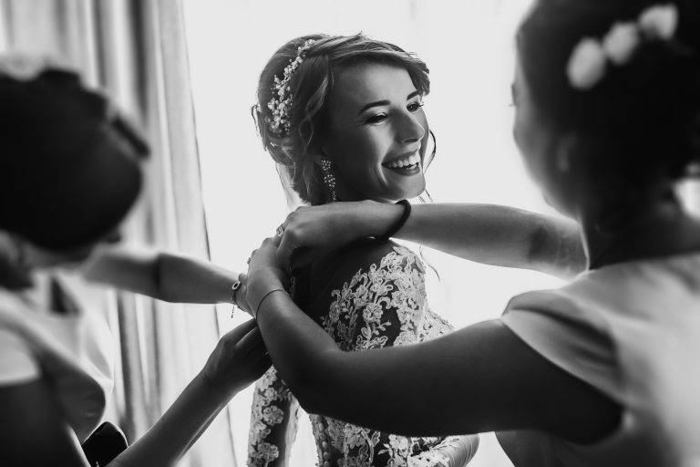 Stylish,Happy,Bride,Dressing,In,Dress,,Smiling,To,Bridesmaids,,At